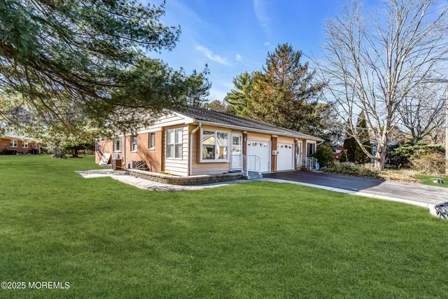 a view of a house with a backyard