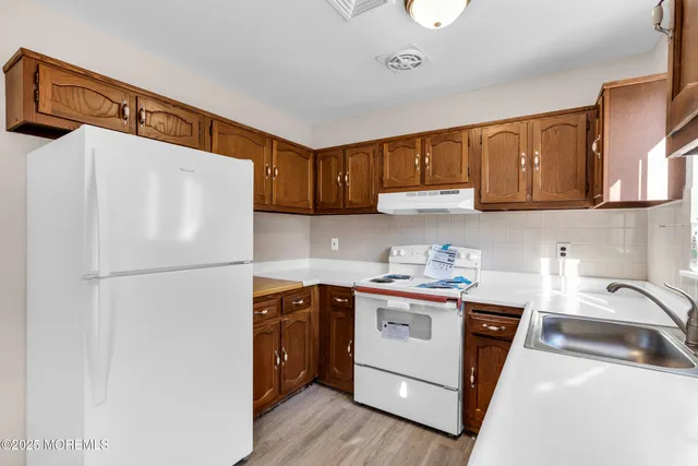 a white refrigerator freezer sitting in a kitchen