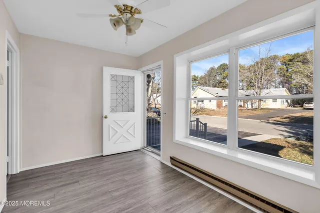 a view of a room with wooden floor and windows