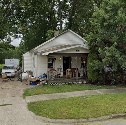 a view of a house with backyard porch and sitting area