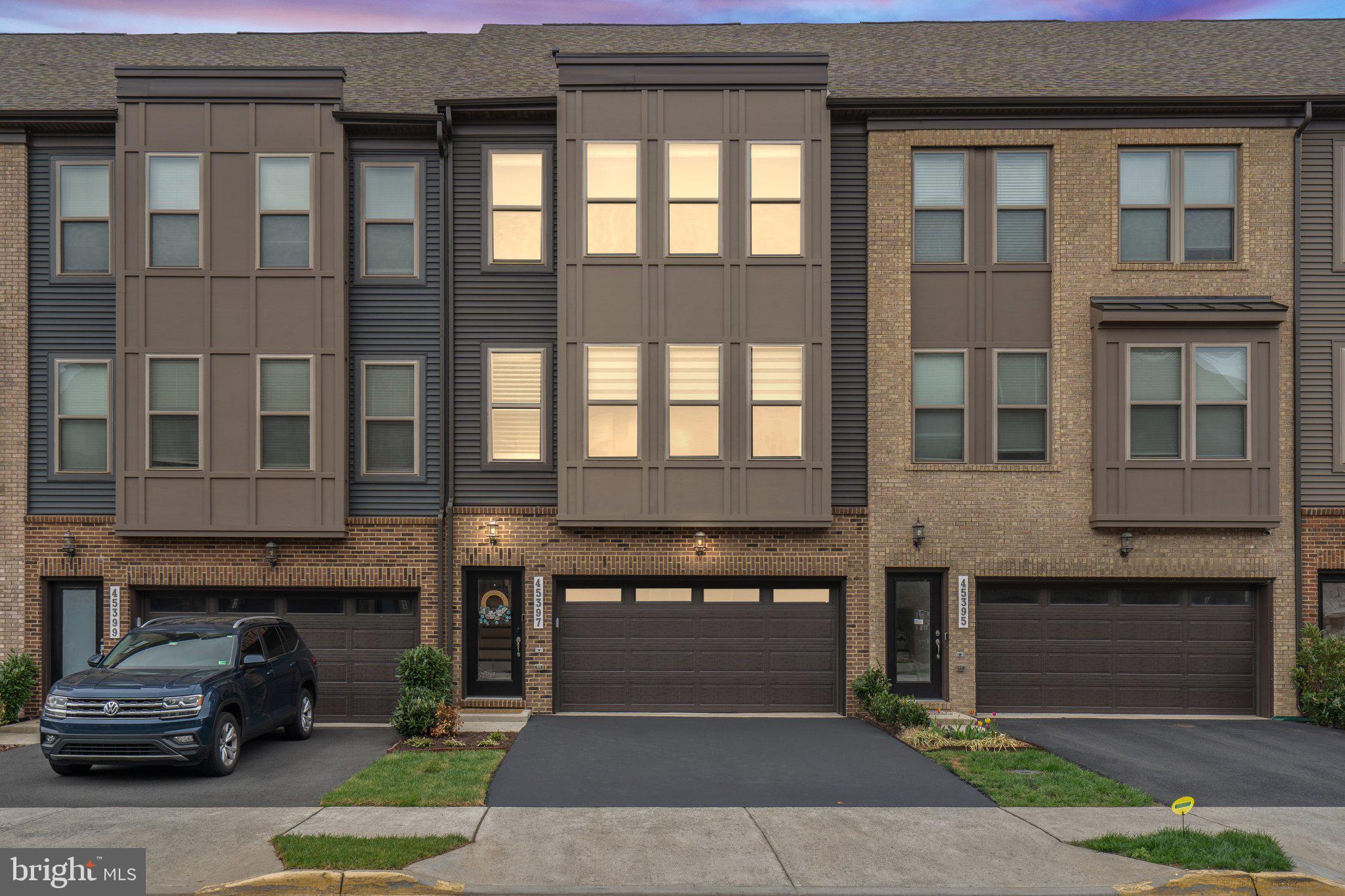 a front view of a building with a garden