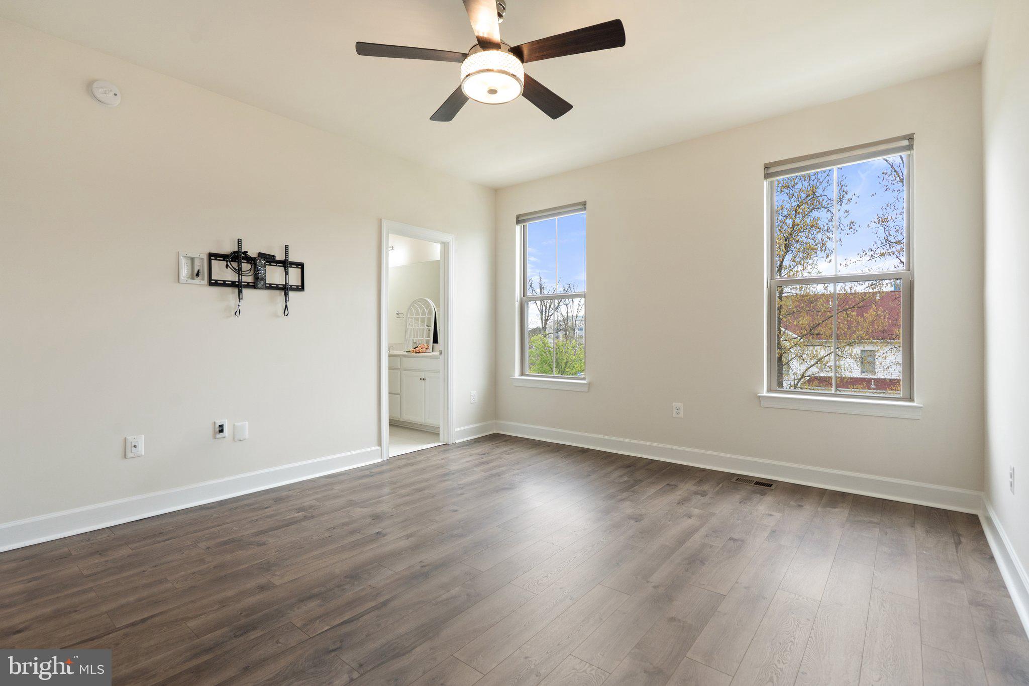 45397 Daveno Square Sterling, VA 20164 - Photo 15 of 44 an empty room with wooden floor chandelier fan and windows