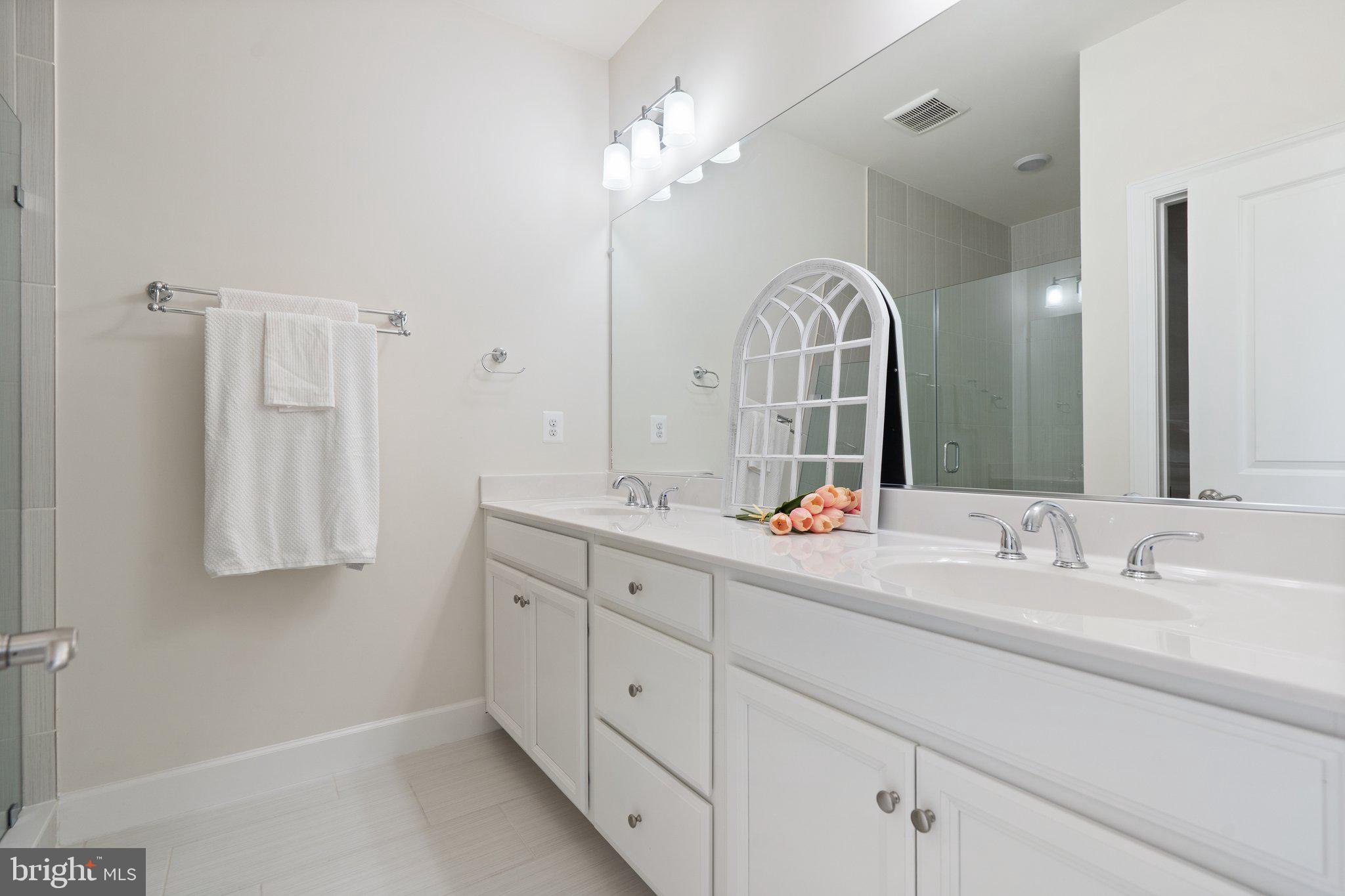 45397 Daveno Square Sterling, VA 20164 - Photo 17 of 44 a bathroom with a double vanity sink and a mirror