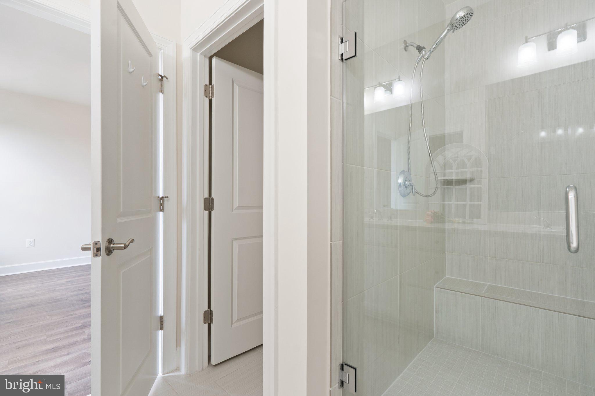 45397 Daveno Square Sterling, VA 20164 - Photo 18 of 44 a bathroom with a glass shower door