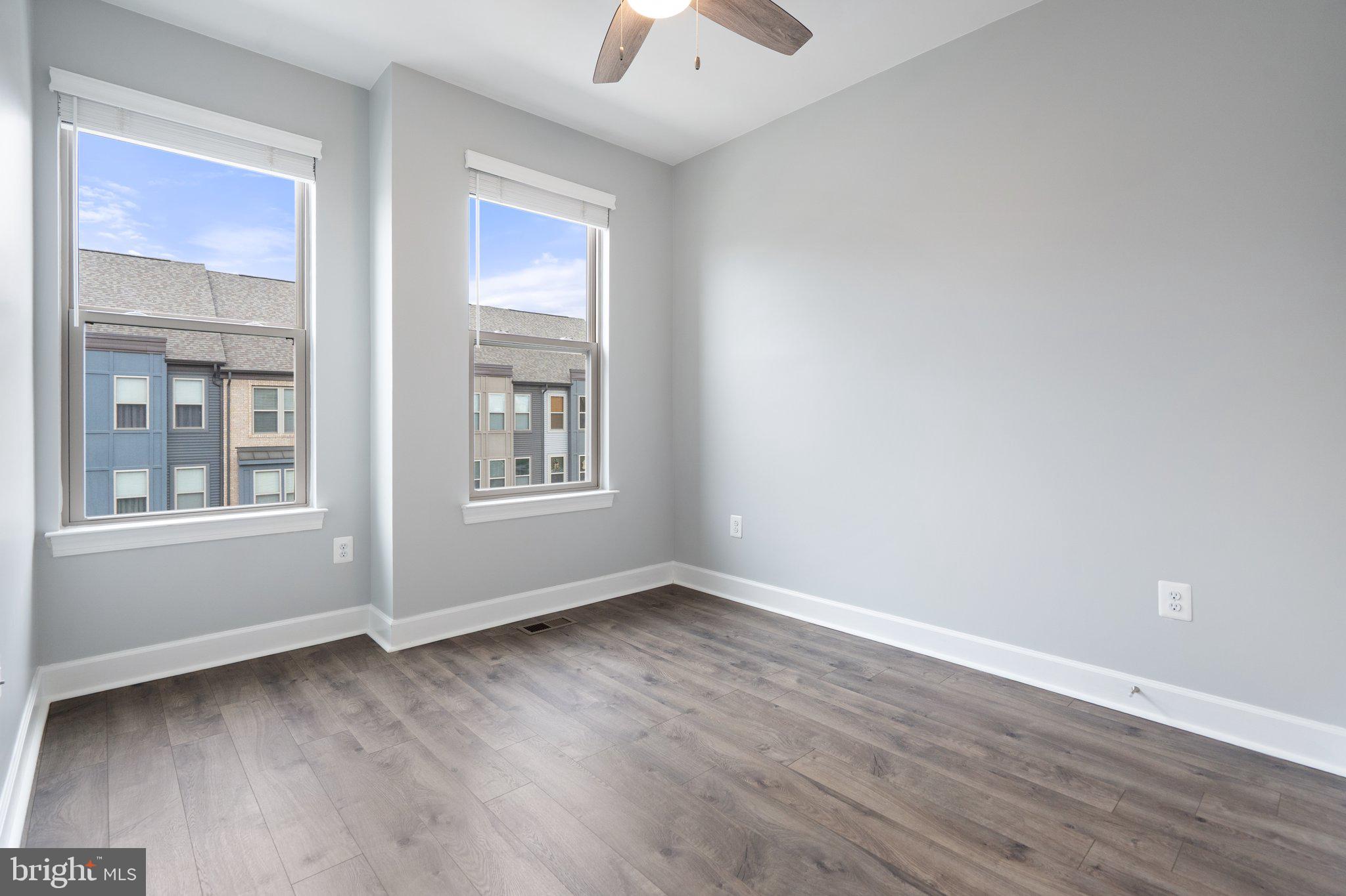 45397 Daveno Square Sterling, VA 20164 - Photo 19 of 44 a view of an empty room with wooden floor and a window