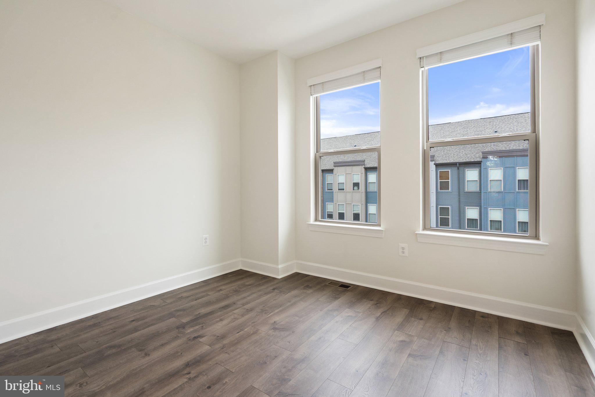 45397 Daveno Square Sterling, VA 20164 - Photo 21 of 44 a view of an empty room with wooden floor and a window