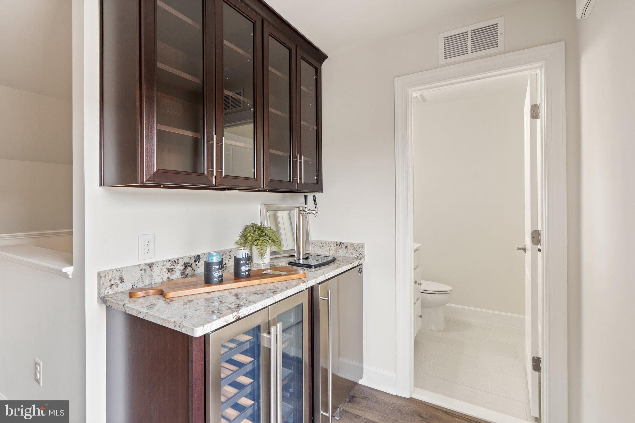45397 Daveno Square Sterling, VA 20164 - Photo 28 of 44 a bathroom with a granite countertop sink and a toilet