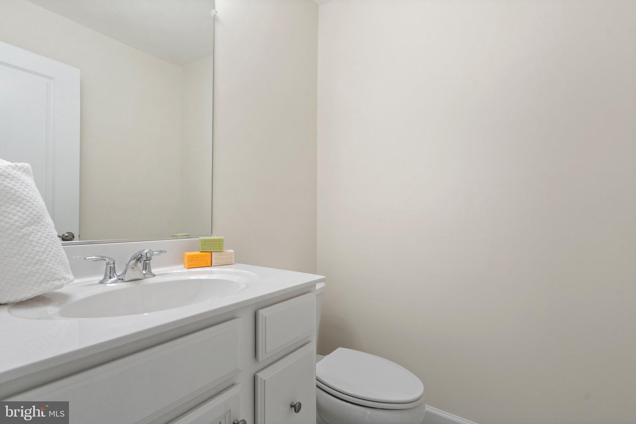 45397 Daveno Square Sterling, VA 20164 - Photo 29 of 44 a bathroom with a sink a toilet and a mirror