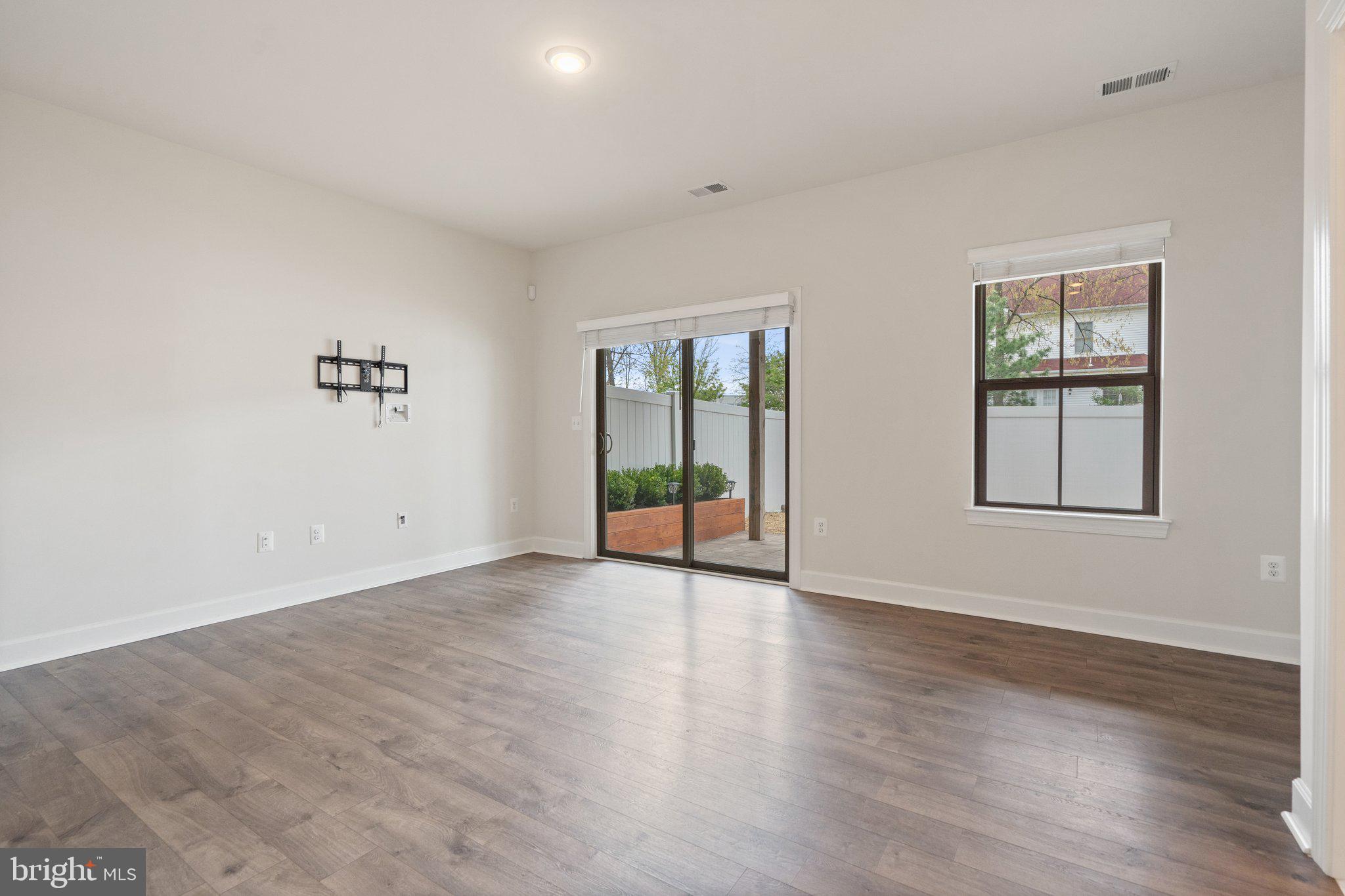 45397 Daveno Square Sterling, VA 20164 - Photo 34 of 44 an empty room with wooden floor and windows