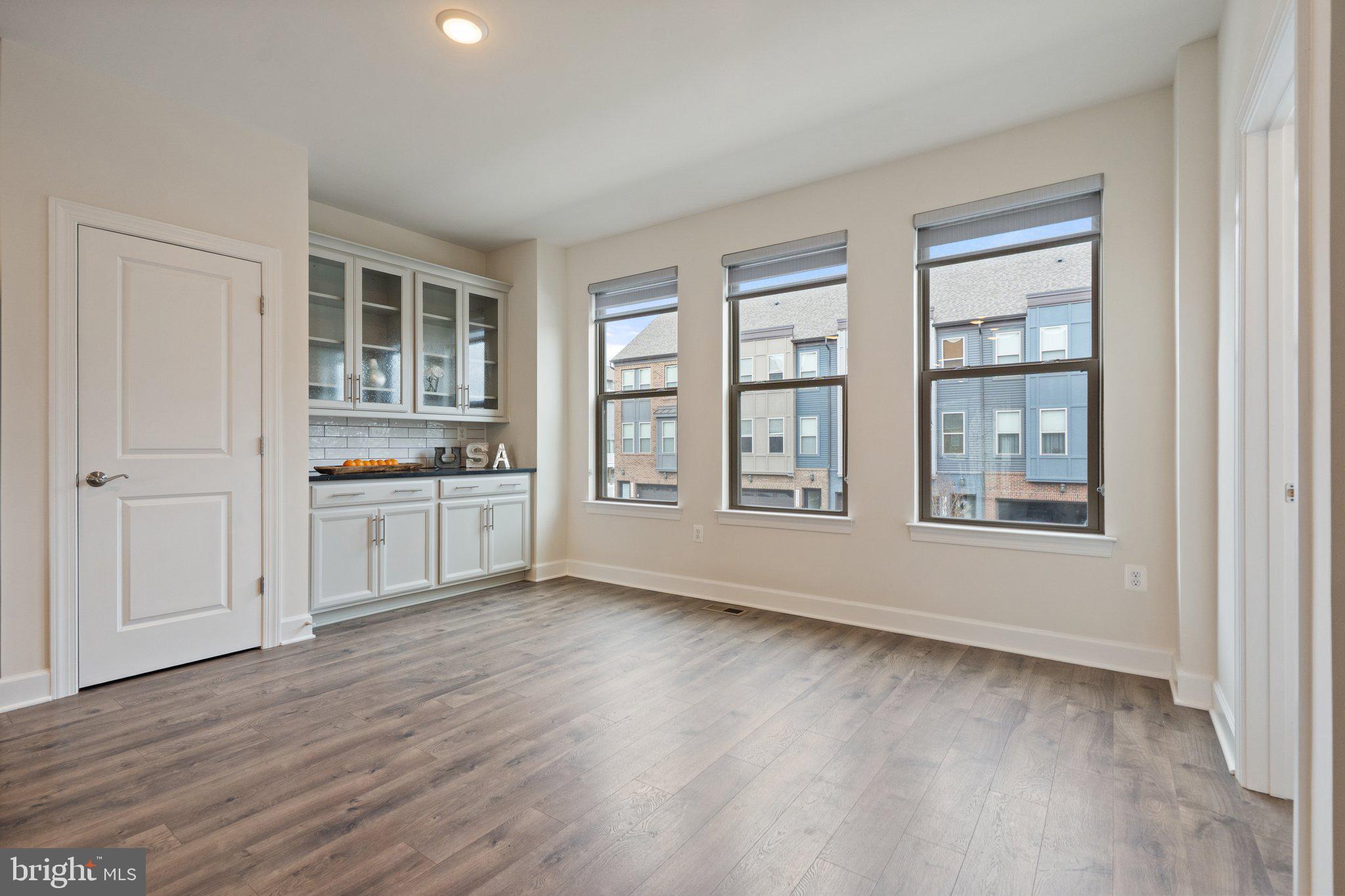 45397 Daveno Square Sterling, VA 20164 - Photo 4 of 44 a view of a big room with wooden floor and windows
