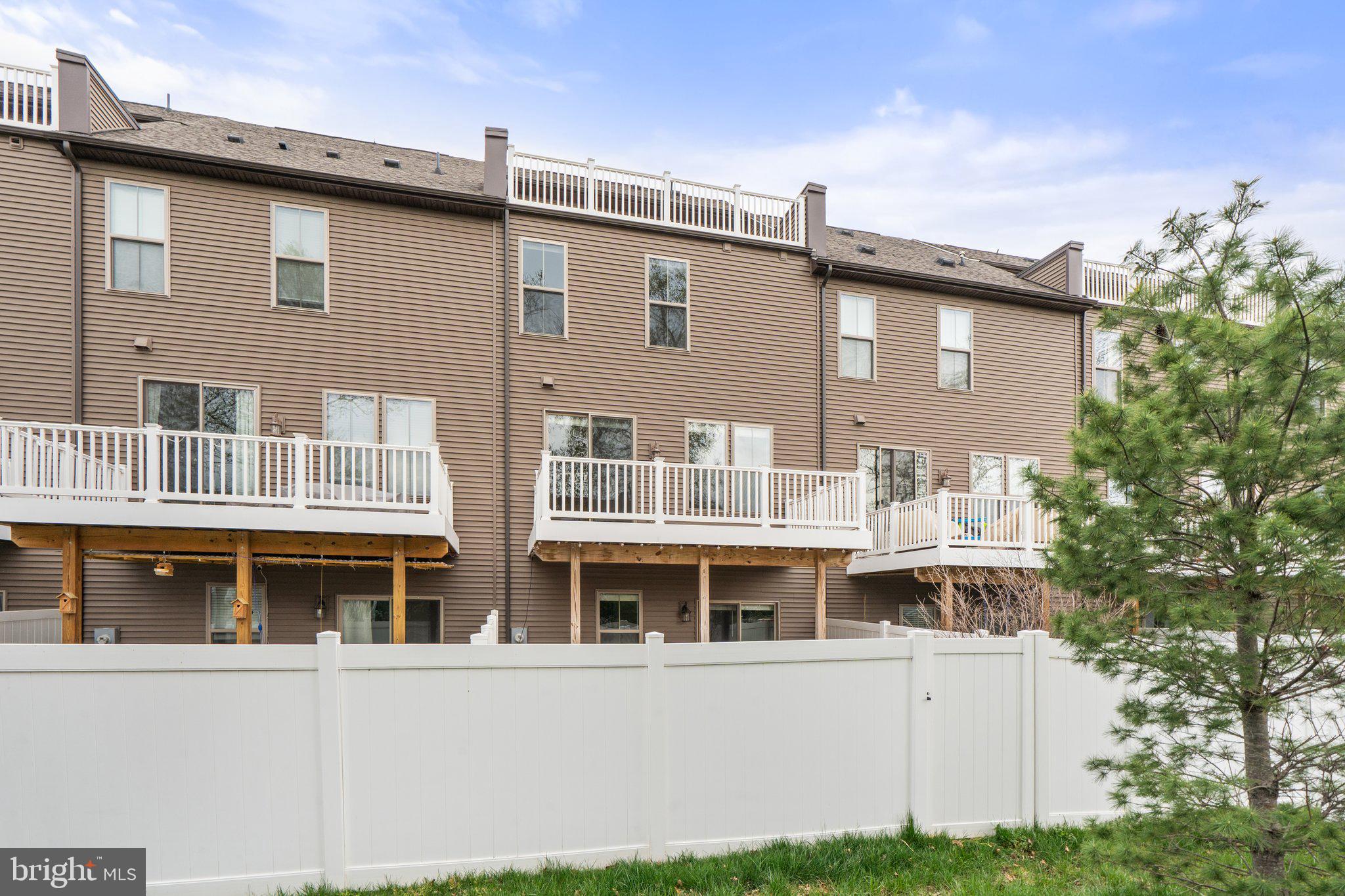 45397 Daveno Square Sterling, VA 20164 - Photo 43 of 44 a front view of a building with a yard and balcony