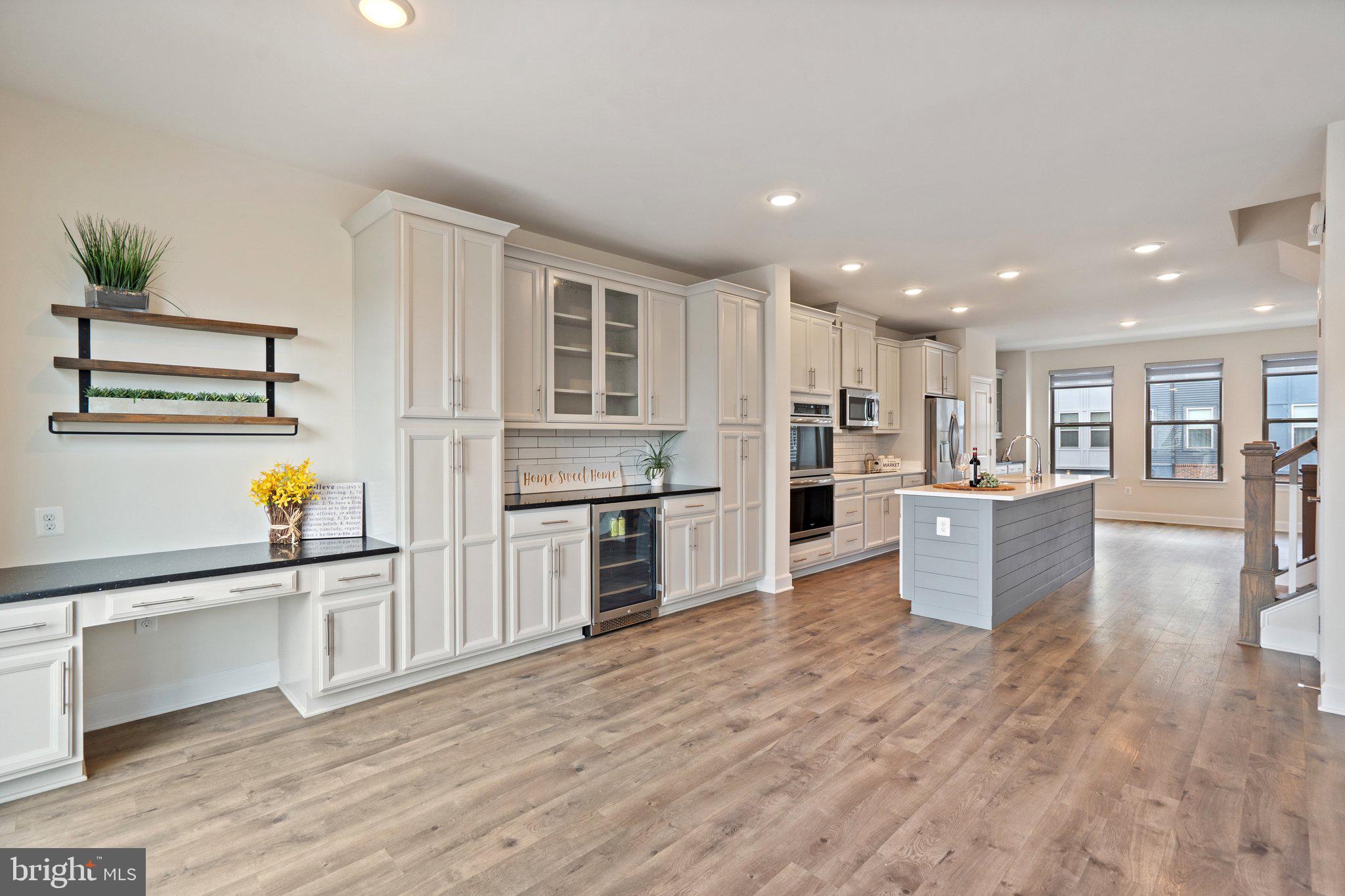 45397 Daveno Square Sterling, VA 20164 - Photo 8 of 44 a large kitchen with stainless steel appliances granite countertop a large counter top a stove a sink and a refrigerator