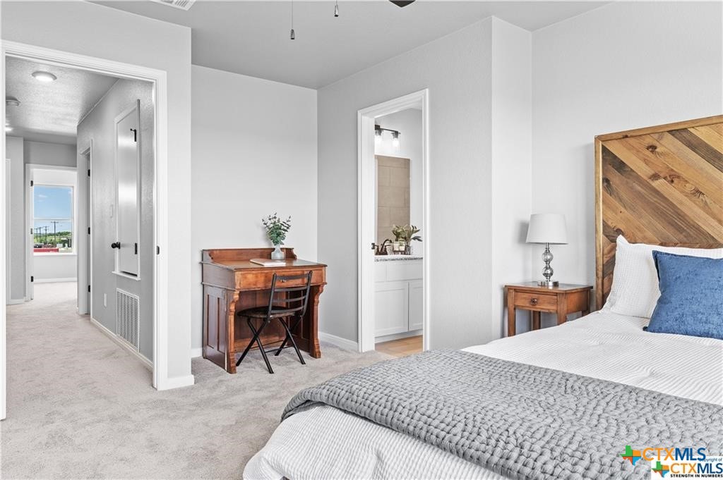 719 Meiomi Drive Temple, TX 76502 - Photo 15 of 32 a bedroom with a bed and a table in it