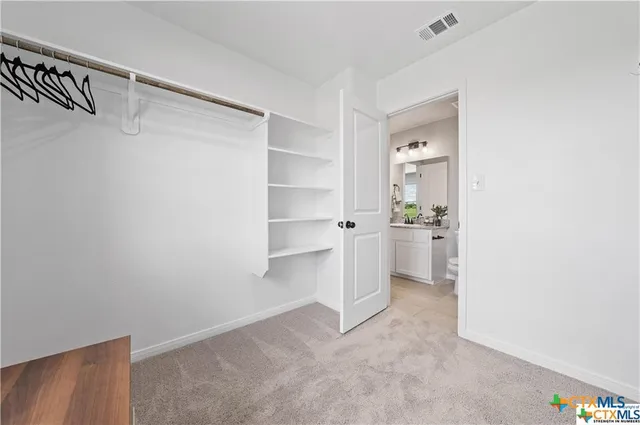 a view of a kitchen with white cabinets
