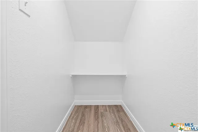 a view of room with wooden floor