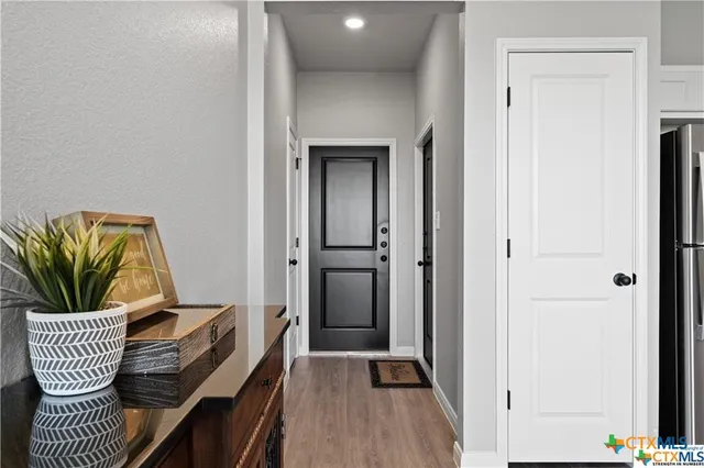 a view of hallway with furniture and a potted plant
