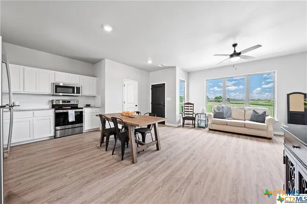 a view of a dining room with furniture window and wooden floor