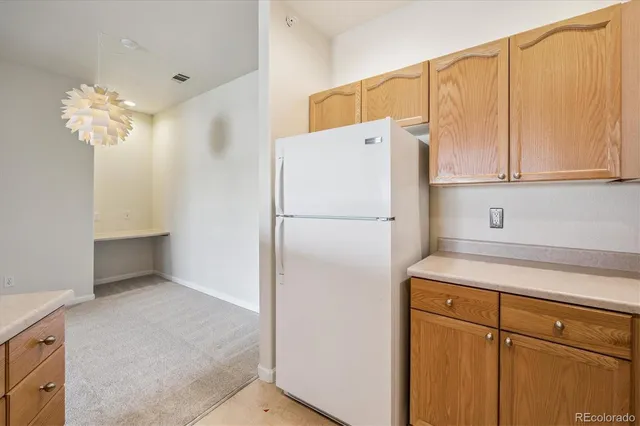 a white refrigerator freezer sitting in a kitchen