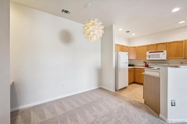 a view of kitchen with refrigerator microwave and cabinets