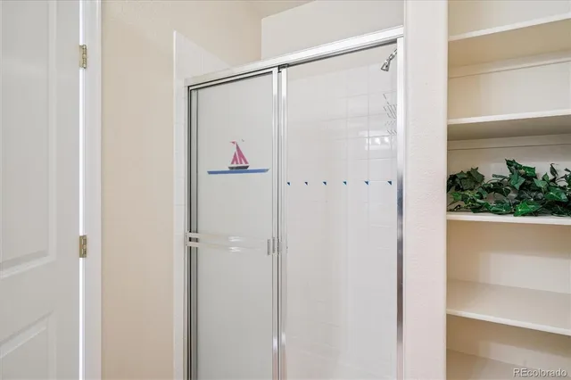 a bathroom with a glass shower door