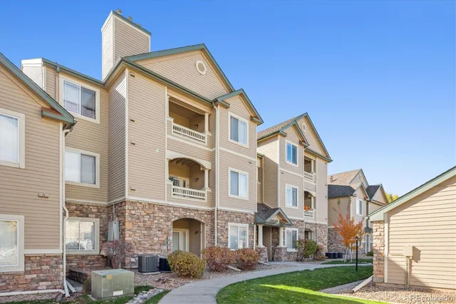 a front view of a residential apartment building with a yard