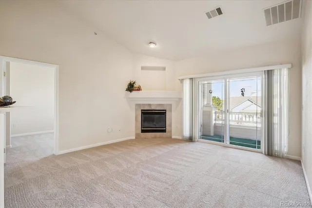 a view of an empty room with a fireplace