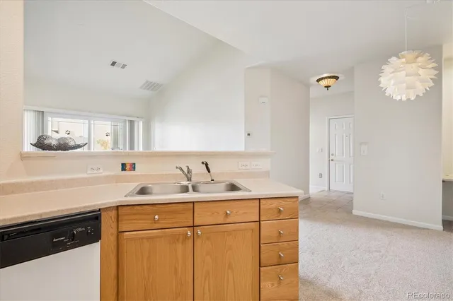 a kitchen with a sink and a refrigerator