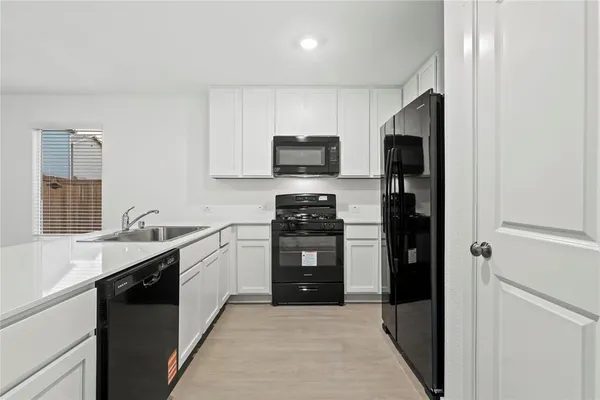 a kitchen with a sink and a stove top oven