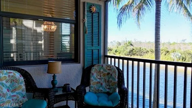a balcony with table and chairs