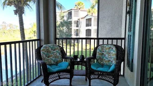 a view of a balcony with furniture and a potted plant