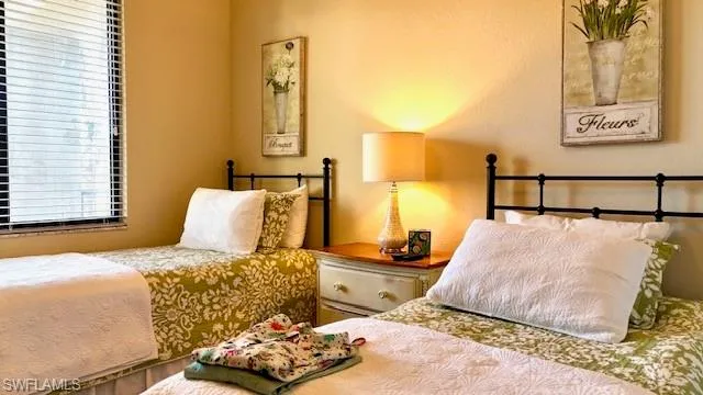 a bedroom with a bed and lamp with window