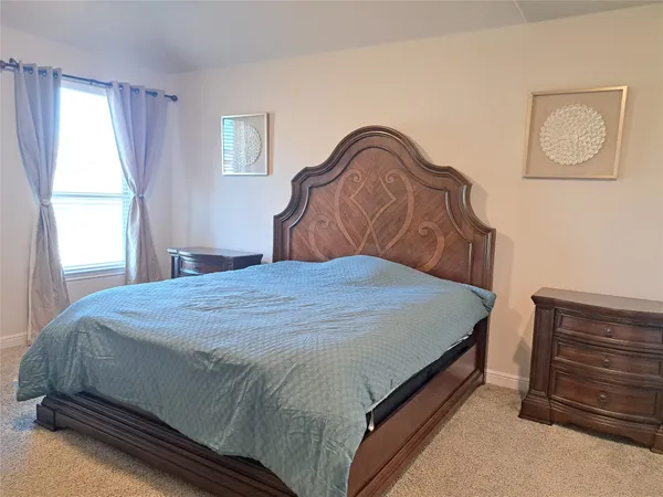 a bedroom with a bed and window