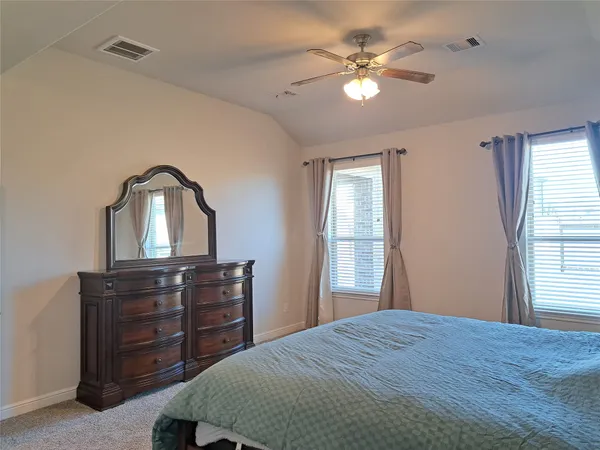 a bedroom with a bed and a dresser