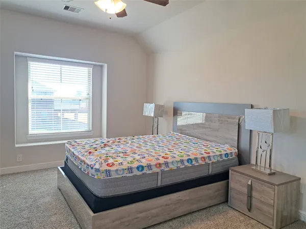a bed sitting in a bedroom next to a window