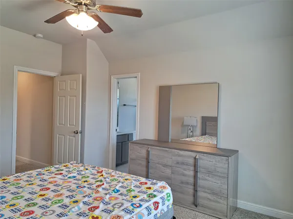 a bedroom with a bed and a dresser