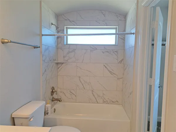 a bathroom with a bathtub and a toilet