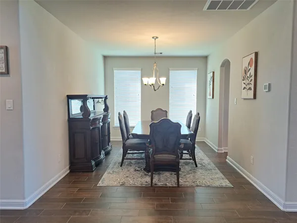 a dining room with furniture and window