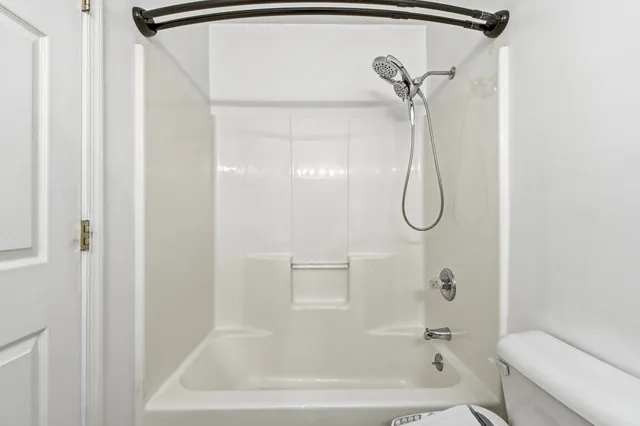 a bathroom with a bath tub with a shower