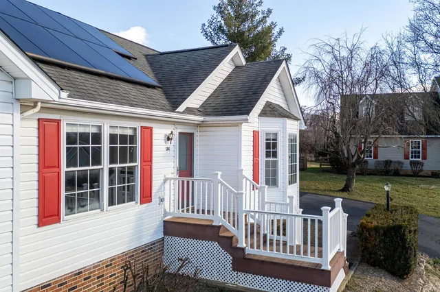 a view of backyard with swimming pool and outdoor seating