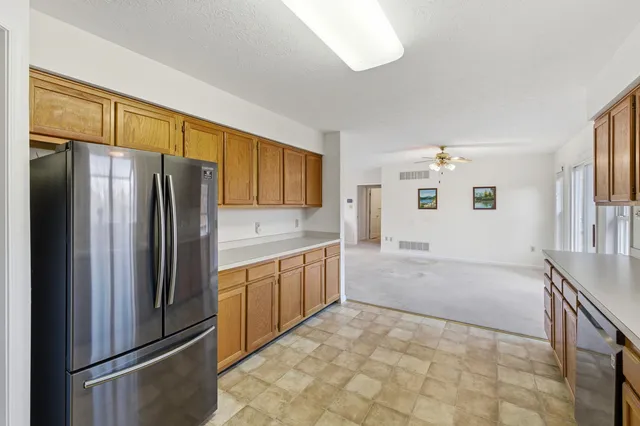 a kitchen with stainless steel appliances a refrigerator and a stove top oven