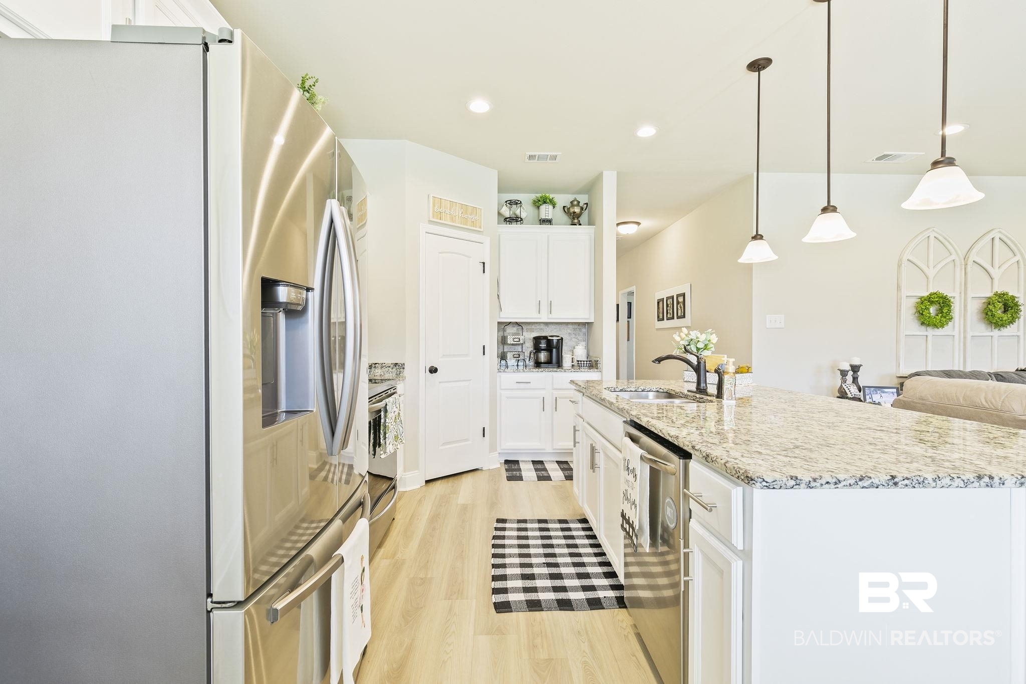 910 Gibson Court Foley, AL 36535 - Photo 19 of 66 Kitchen featuring stainless steel appliances, white cabinets, sink, and pendant lighting