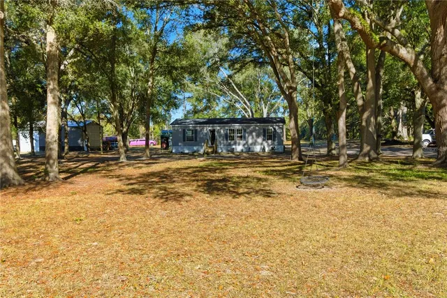 a front view of a building with a garden