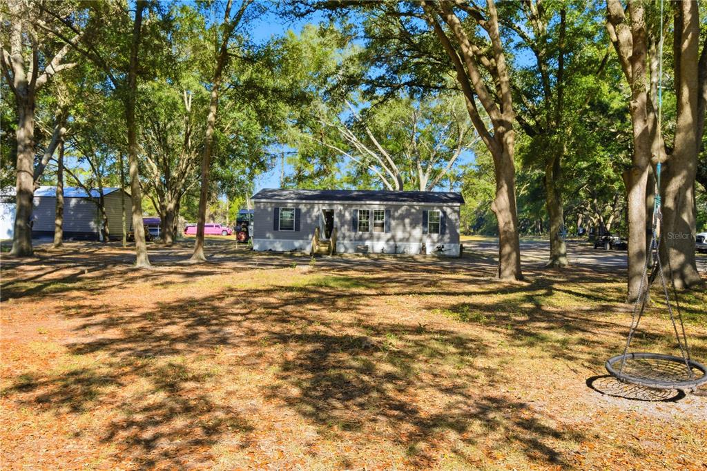 4506 Northwest 10th Street Bell, FL 32619 - Photo 12 of 50 a front view of a building with a garden