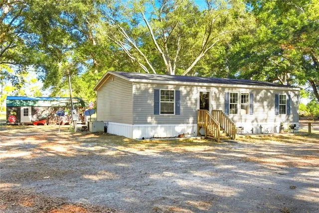 a view of a house with wooden fence