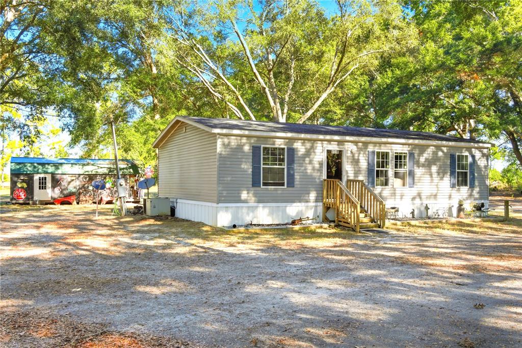 4506 Northwest 10th Street Bell, FL 32619 - Photo 13 of 50 a view of a house with backyard and sitting area