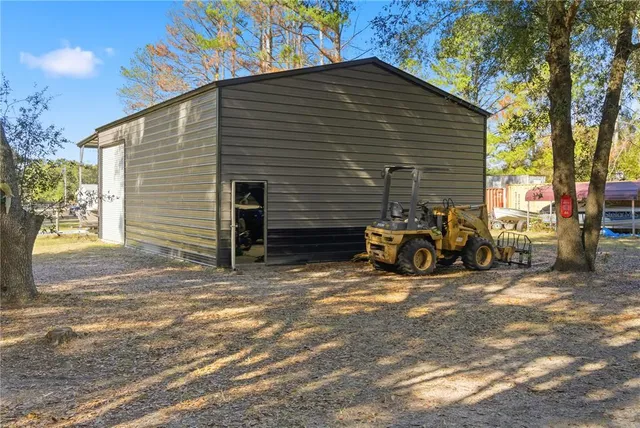 a backyard of a house with table and chairs