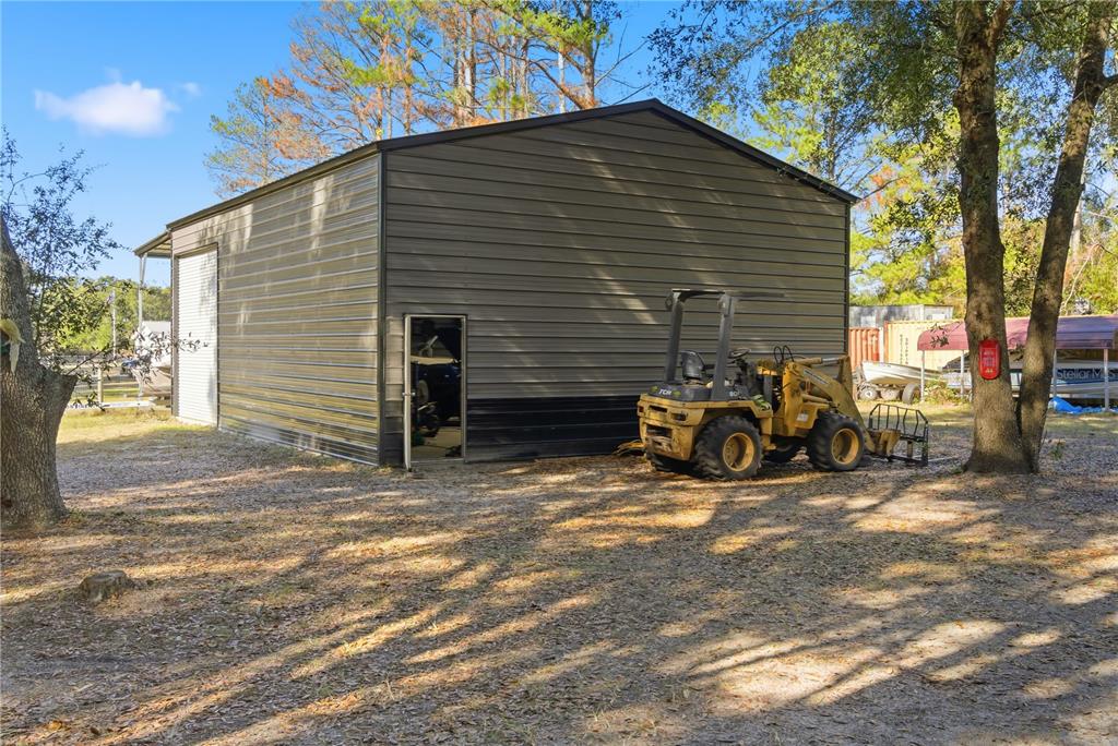 4506 Northwest 10th Street Bell, FL 32619 - Photo 16 of 50 a view of a garage with parked cars