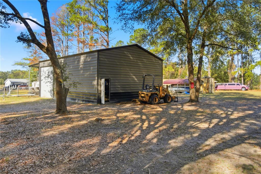4506 Northwest 10th Street Bell, FL 32619 - Photo 17 of 50 a backyard of a house with table and chairs