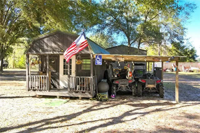 a view of a house with a yard and tree
