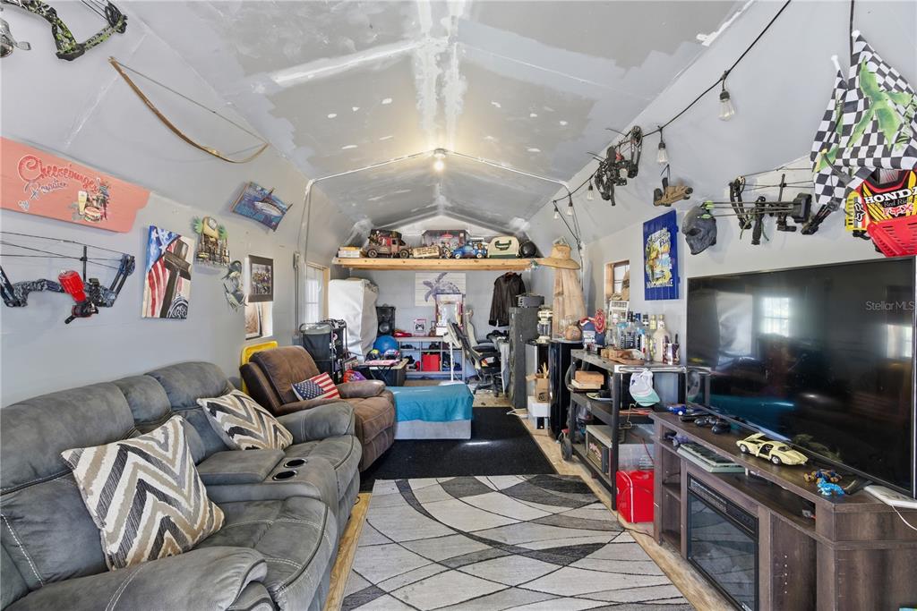 4506 Northwest 10th Street Bell, FL 32619 - Photo 23 of 50 a room with lots of furniture and a flat screen tv